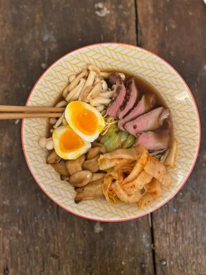 this is a photo of ramen with beef and mushrooms