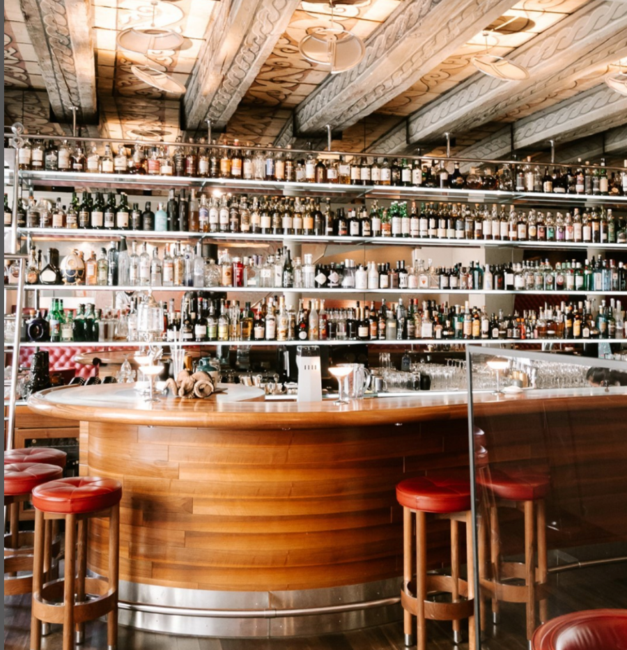 widder bar in zurich a wooden bar with bottles behind
