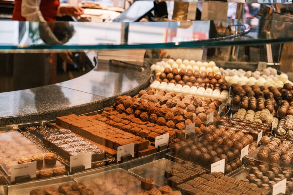 counter of a chocolate shop, with a variety of chocolates on display