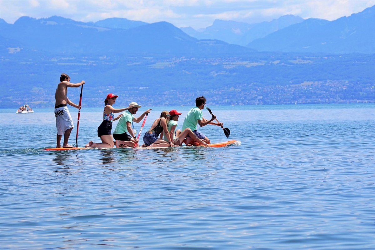 group of people paddleboarding on lac leman