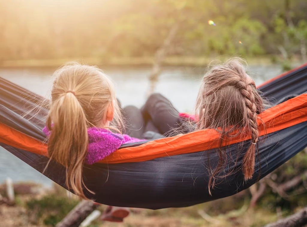 Two kids sitting in a hammock