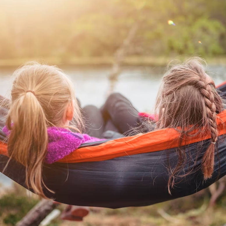 Two kids sitting in a hammock