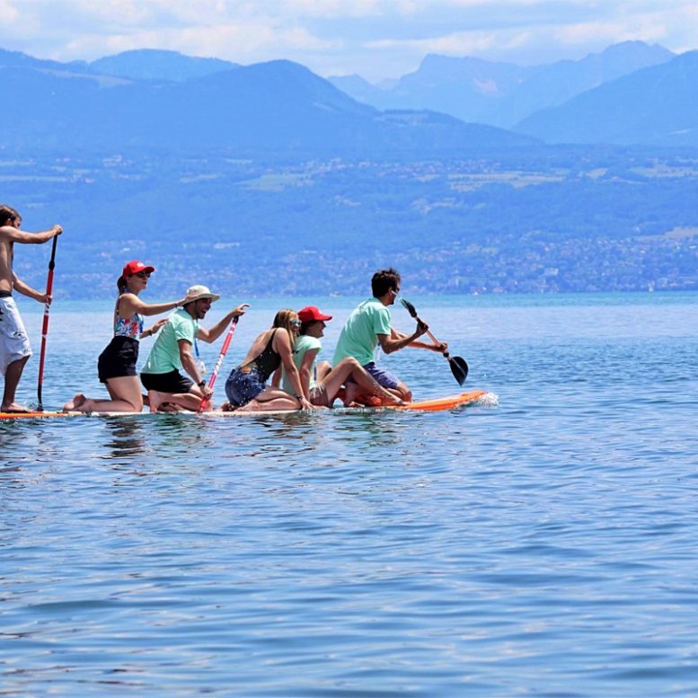 group of people paddleboarding on lac leman